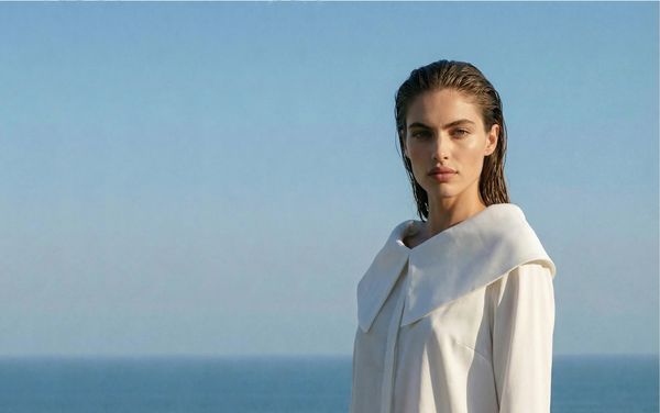 AI model wearing white blouse at blue sky background